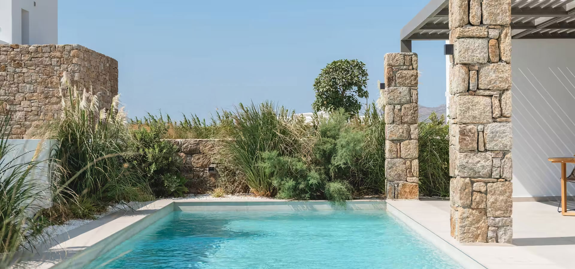 Outdoor swimming pool surrounded by Mediterranean planting