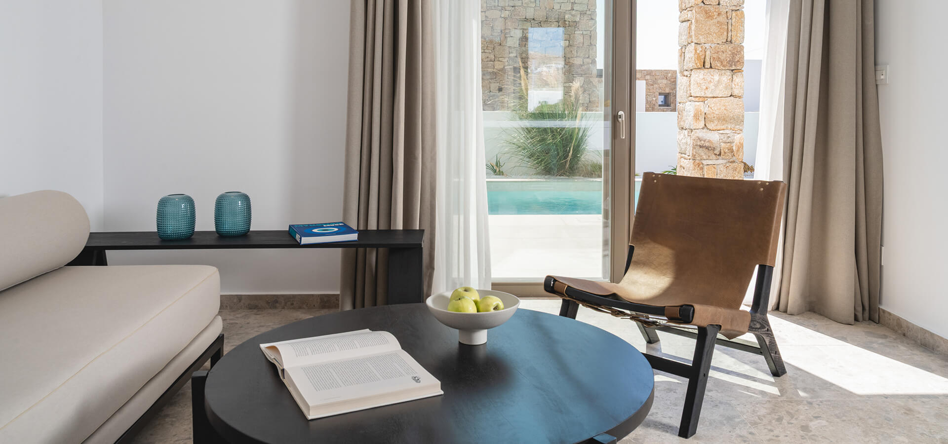 Cozy living room with elegant furniture and a pool view