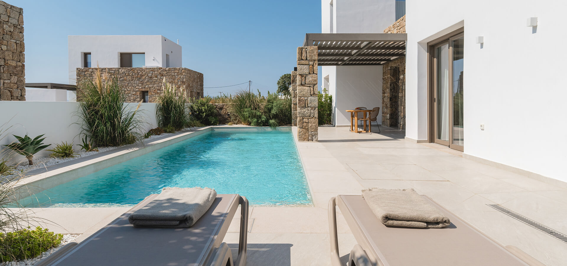 Swimming pool area under the sun and blue sky